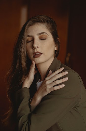Portrait Photo of Woman Posing with Her Arms Crossed and Her Eyes Closed
