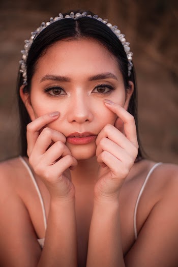 Portrait Photo of Woman Posing with Her Hands on Her Cheeks