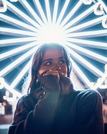 Portrait Photo of Woman Standing In Front of Lit Ferris Wheel Looking Away