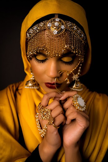 Portrait Photo of Woman Wearing Gold-colored Jhumka Earrings and Yellow Hijab 