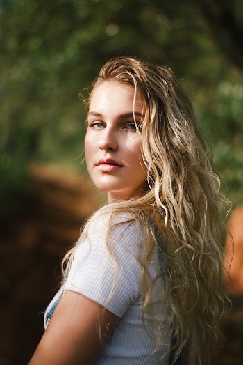 Portrait Photo of Woman Wearing White Top