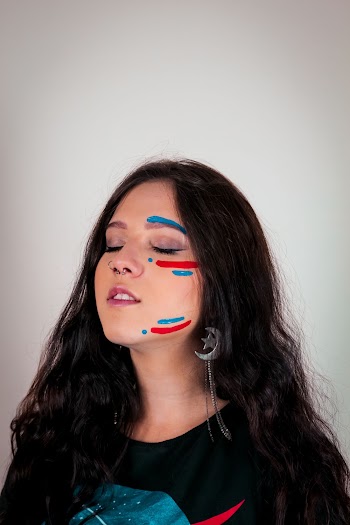 Portrait Photo of Woman With Face Paint Posing With Her Eyes Closed