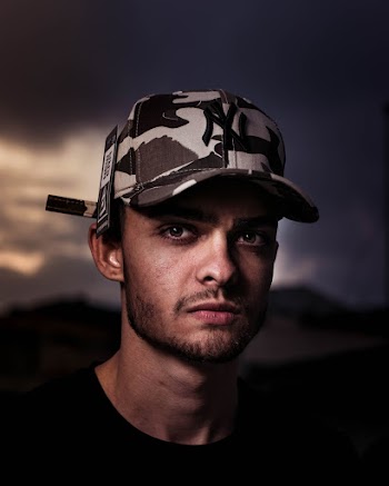 Portrait Photography of a Man Wearing a Camouflage Cap