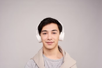 Portrait Photography of Man Wearing White Wireless Headphones
