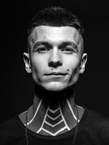 portrait photography of man with neck tattoos