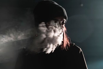portrait photography of person blowing smoke
