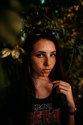 portrait photography of woman behind leaves