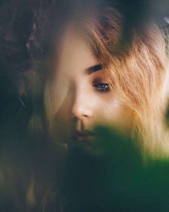 portrait photography of woman near leaves