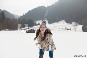 Portrait playful young woman in snowy field