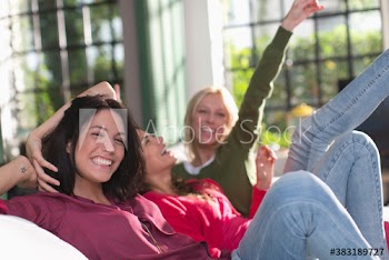 Portrait playful young women friends on sofa