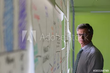 Portrait serious creative businessman brainstorming in office