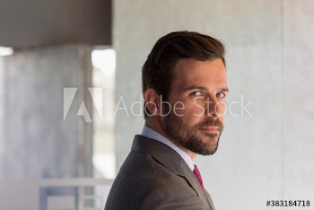 Portrait serious handsome corporate businessman