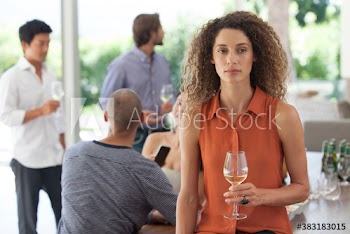 Portrait serious unhappy young woman drinking wine at party with friends