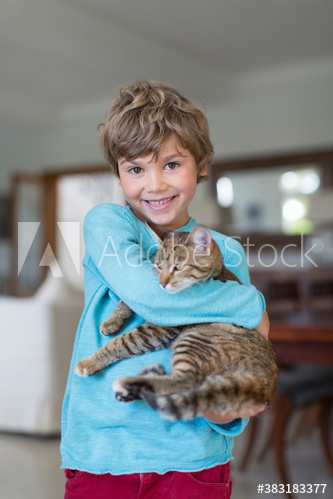 Portrait smiling boy holding cat
