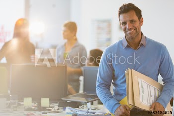 Portrait smiling businessman in office