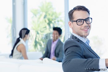 Portrait smiling businessman on sofa