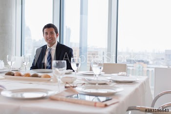 Portrait smiling corporate businessman at conference lunch table