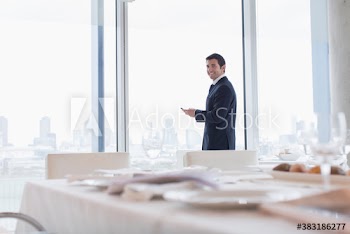 Portrait smiling corporate businessman at conference window