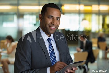 Portrait smiling corporate businessman using digital tablet in office