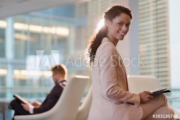 Portrait smiling corporate businesswoman working in office