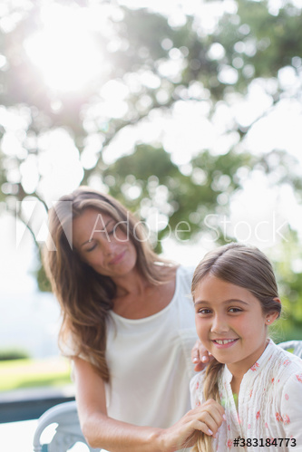 Portrait smiling daughter with mother in sunny park