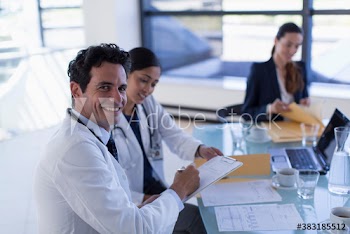 Portrait smiling doctors meeting in hospital conference room