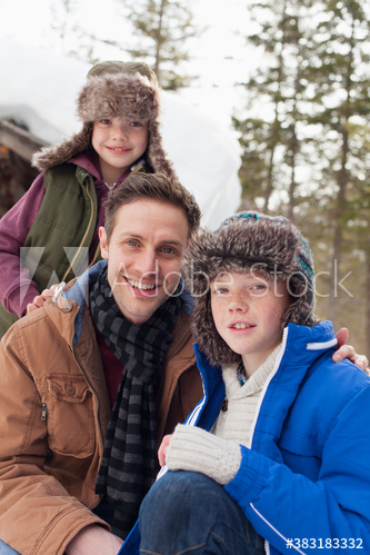 Portrait smiling father and children in warm clothing
