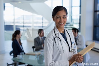 Portrait smiling female doctor in hospital meeting