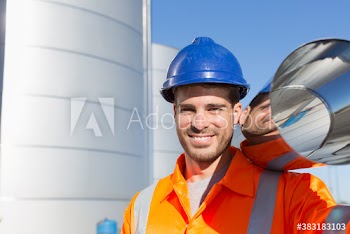Portrait smiling male worker carrying steel tank