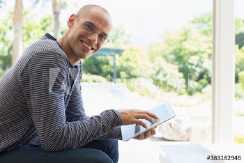 Portrait smiling man using digital tablet