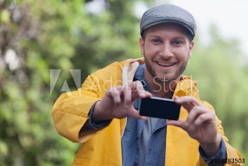 Portrait smiling man with camera phone