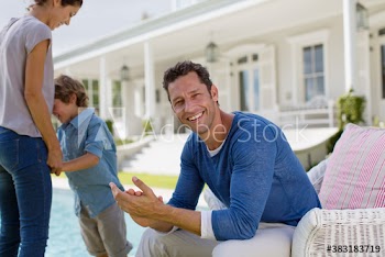 Portrait smiling man with family on patio
