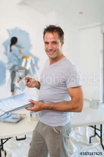 Portrait smiling man with paint tray painting