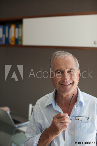Portrait smiling senior man holding eyeglasses