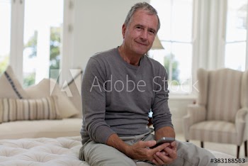 Portrait smiling senior man using smart phone