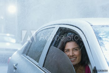 Portrait smiling woman driving car in rain