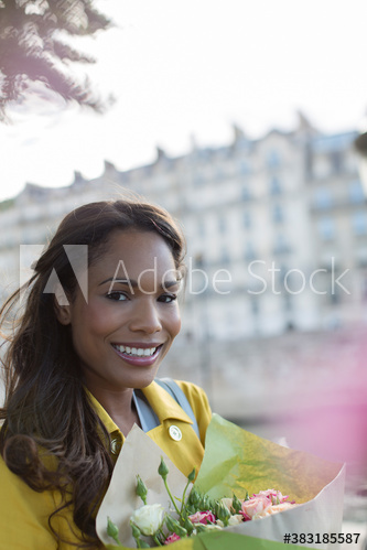 Portrait smiling woman with fresh flowers, Paris, France