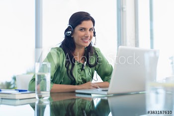Portrait smiling woman with headphones working at laptop