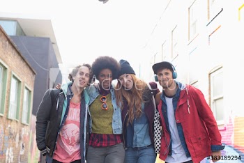 Portrait smiling young friends on city street
