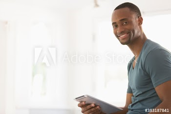 Portrait smiling young man with digital tablet
