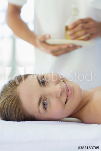 Portrait smiling young woman ready for massage in spa