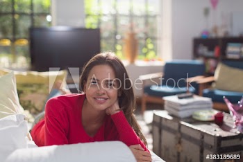 Portrait smiling young woman relaxing on sofa