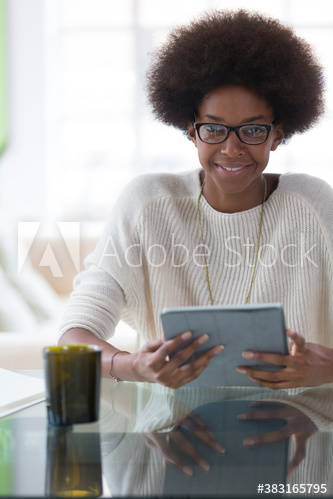 Portrait smiling young woman with afro using digital tablet