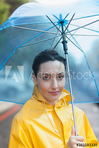 Portrait woman in raincoat with umbrella