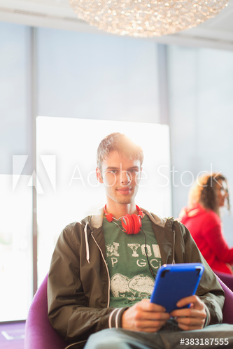 Portrait young man with headphones using digital tablet