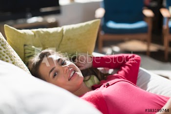 Portrait young woman relaxing on sofa