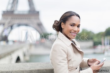 Portrait young woman with smart phone, Eiffel Tower, Paris, France
