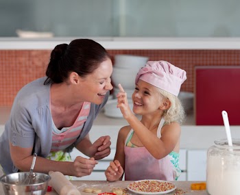 Potrait of money and Daugther having fun together in Kitchen