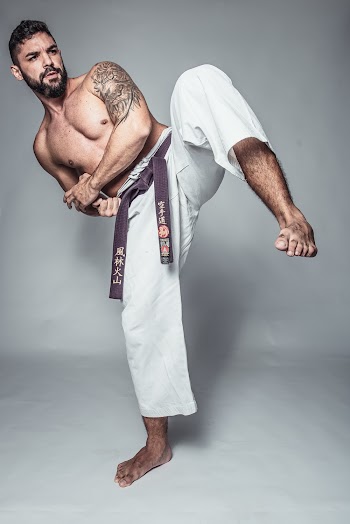 Potrait Photo of Topless Man in Kicking Position