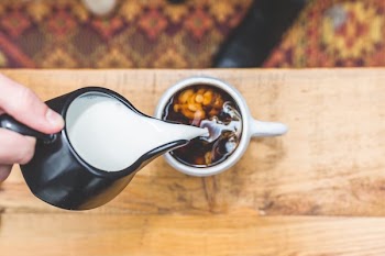 Pouring Cream Into Coffee